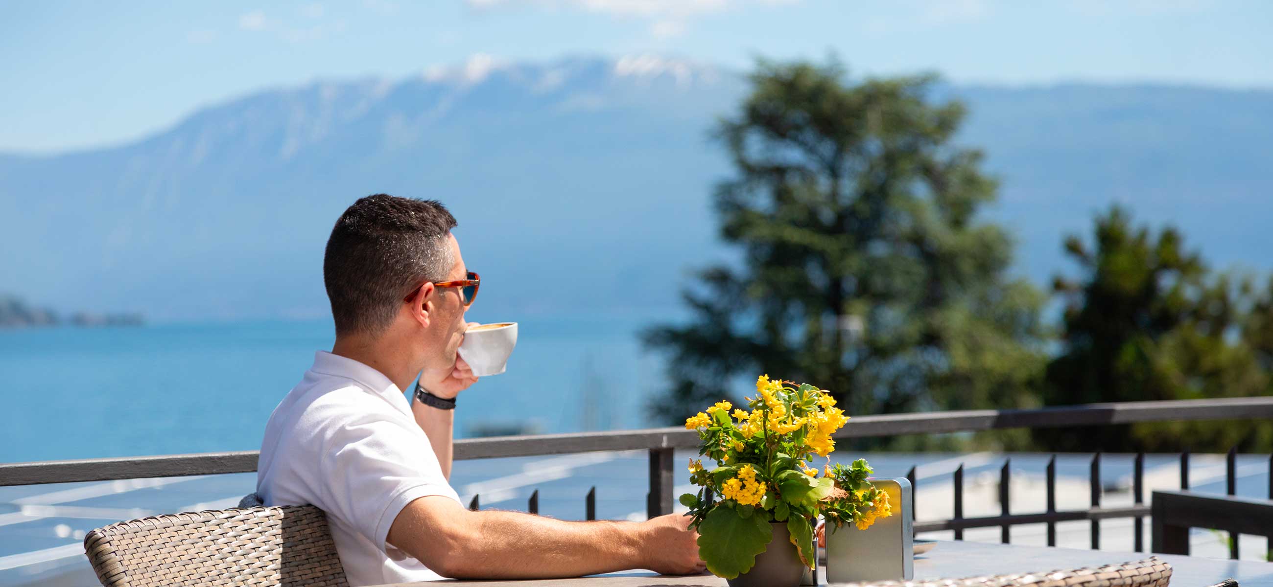 Swimming pool at Camping Eden with sunbathing area and Lake Garda view